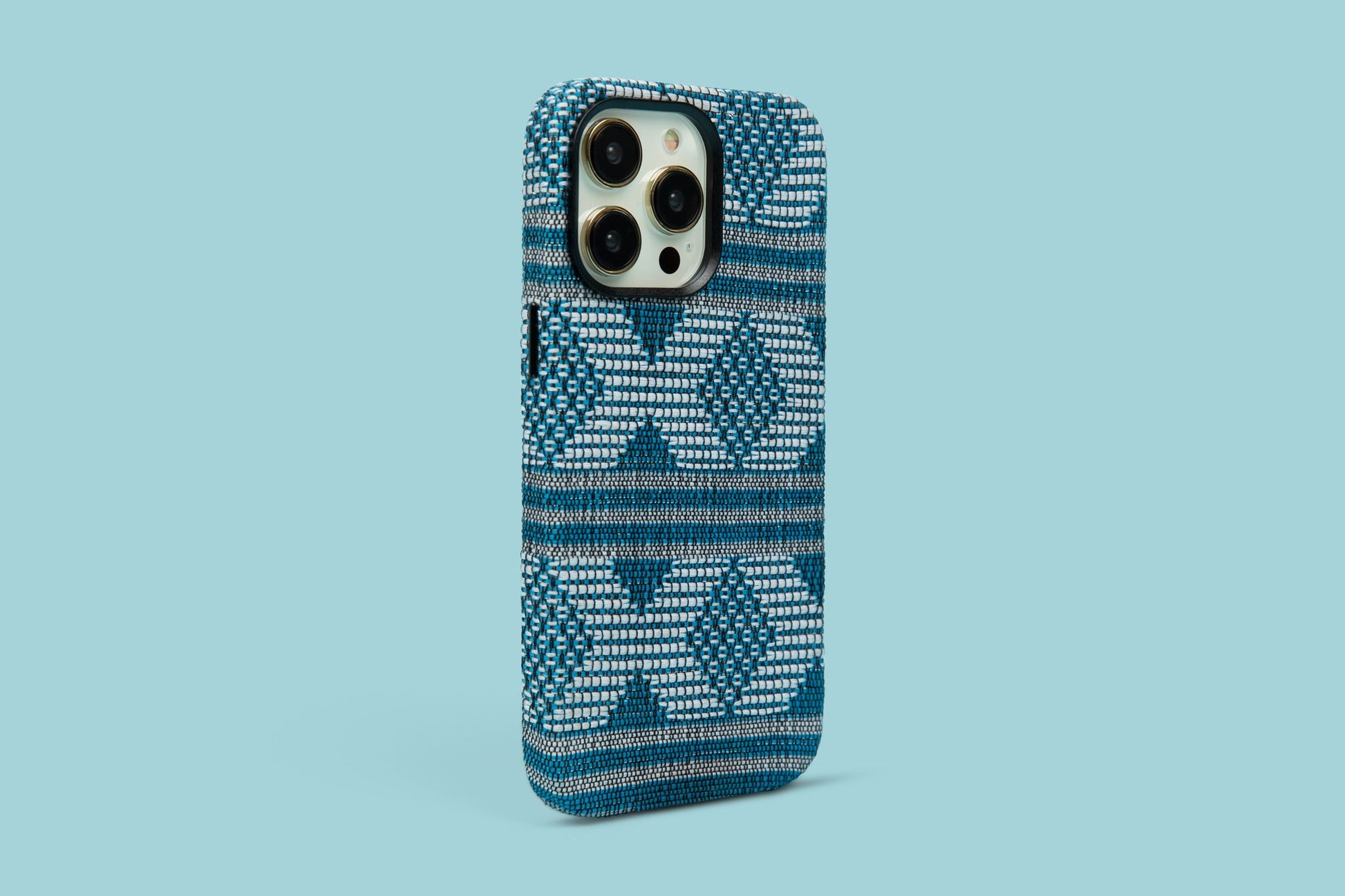 Bold patterned phone case in bold blue and white hues against a serene blue background, a statement piece for iPhone 12, 13, and 14 Pro Max