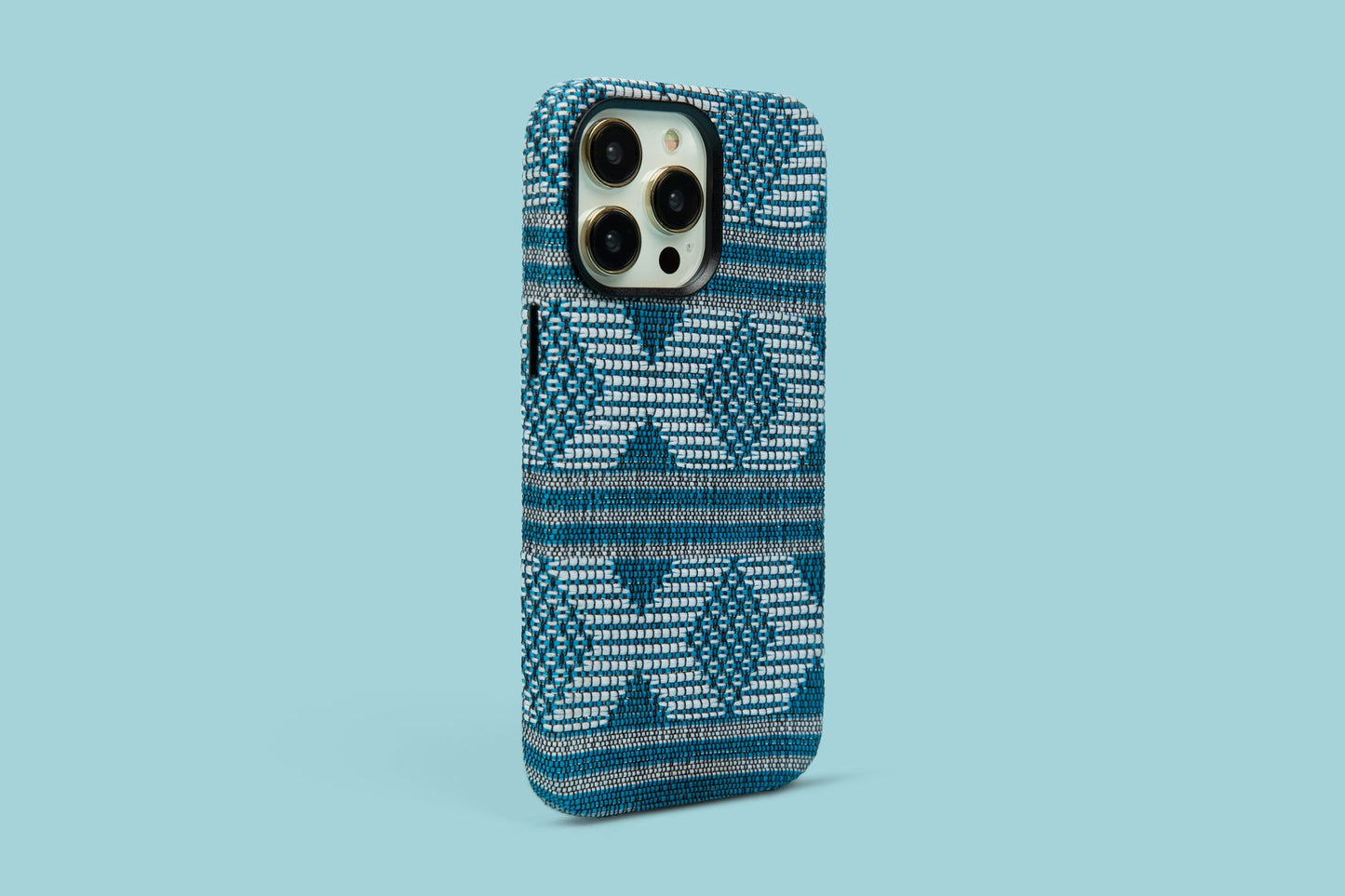 Bold patterned phone case in bold blue and white hues against a serene blue background, a statement piece for iPhone 12, 13, and 14 Pro Max