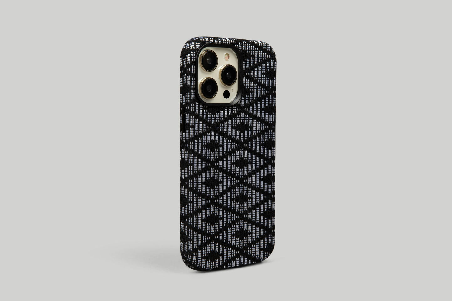 Zulu Zigzag phone case with black and white patterns against a minimalist grey backdrop, embodying timeless style for iPhone 12, 13, and 14 Pro Max, blending with any ensemble.